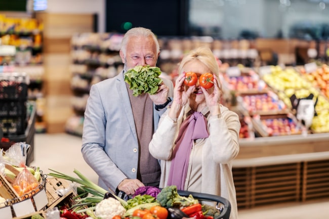 elderly couple doing grocery shopping